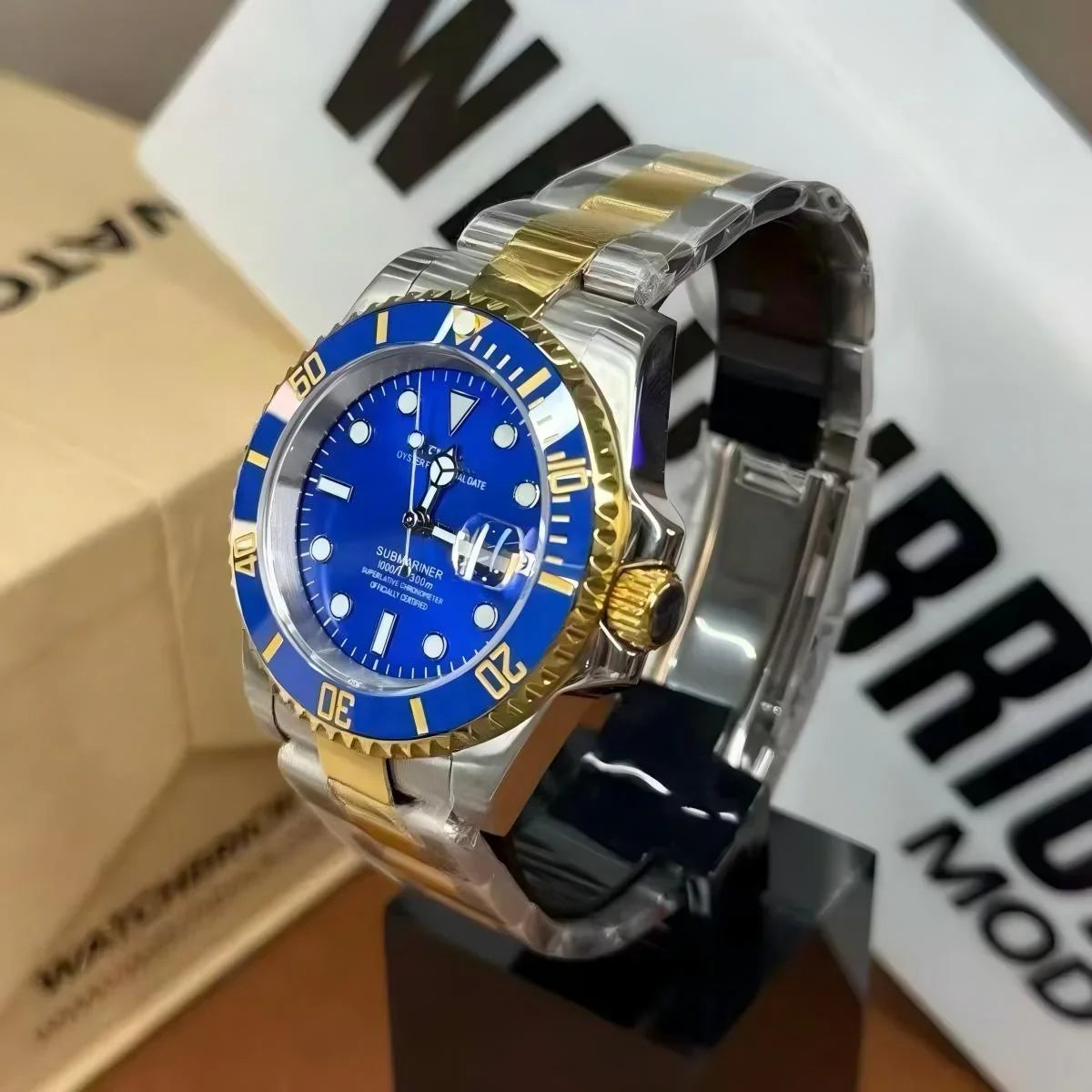 Luxury two-tone dive watch with blue dial, gold bezel, and stainless steel bracelet on display