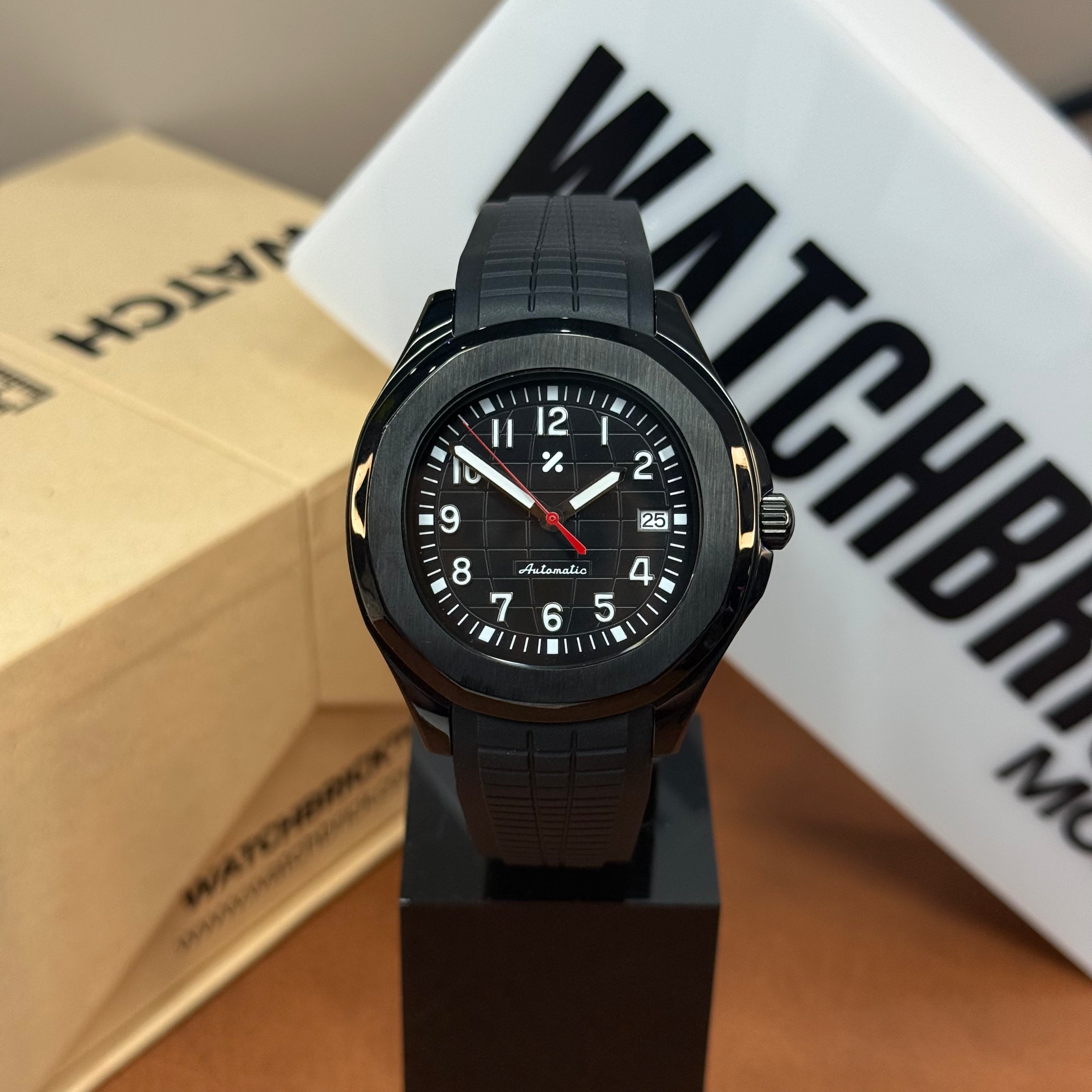 Black Seiko mod watch with black rubber strap, automatic movement, and date display