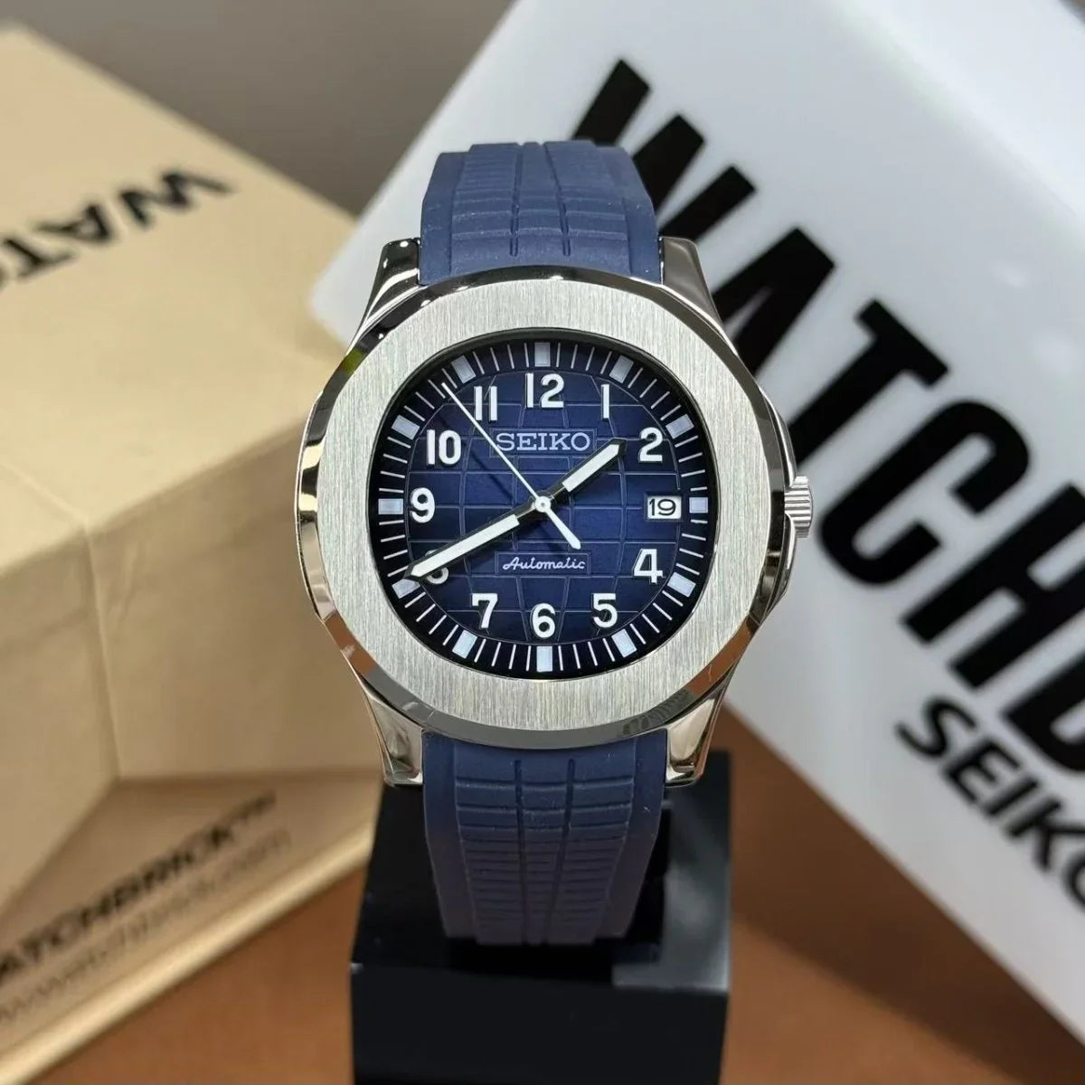 Blue Seiko mod watch with black grid dial, NH35 automatic movement, and textured blue strap