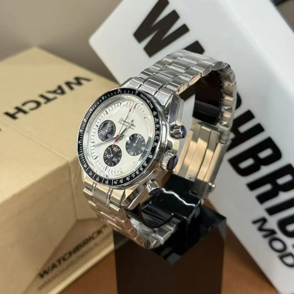 Stainless steel Seiko mod watch with white dial, black subdials, and tachymeter bezel.