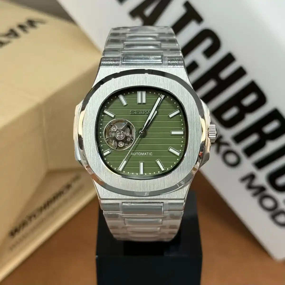 Green open-heart automatic Seiko mod watch with stainless steel bracelet