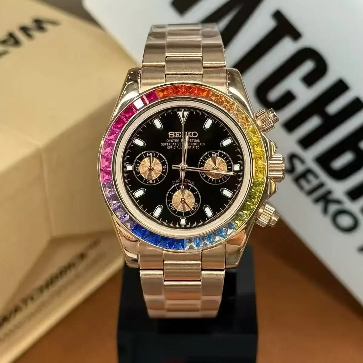Rose gold Seiko mod watch with rainbow bezel and black dial, luxury chronograph design