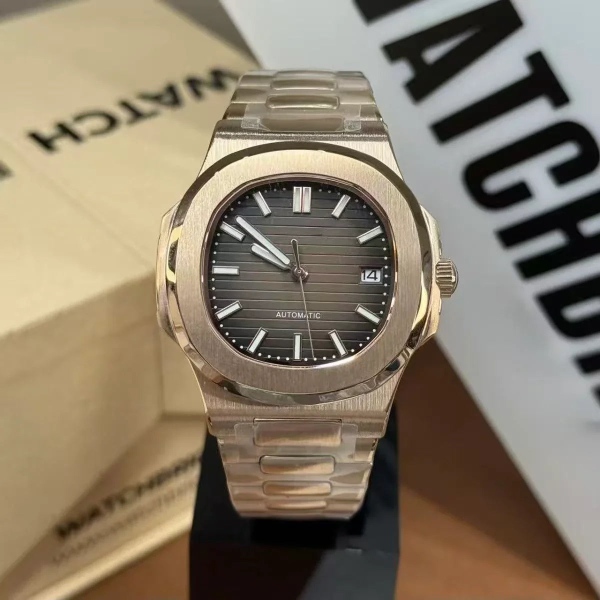 Stainless steel automatic mod watch with black dial, date window, and horizontal markers.