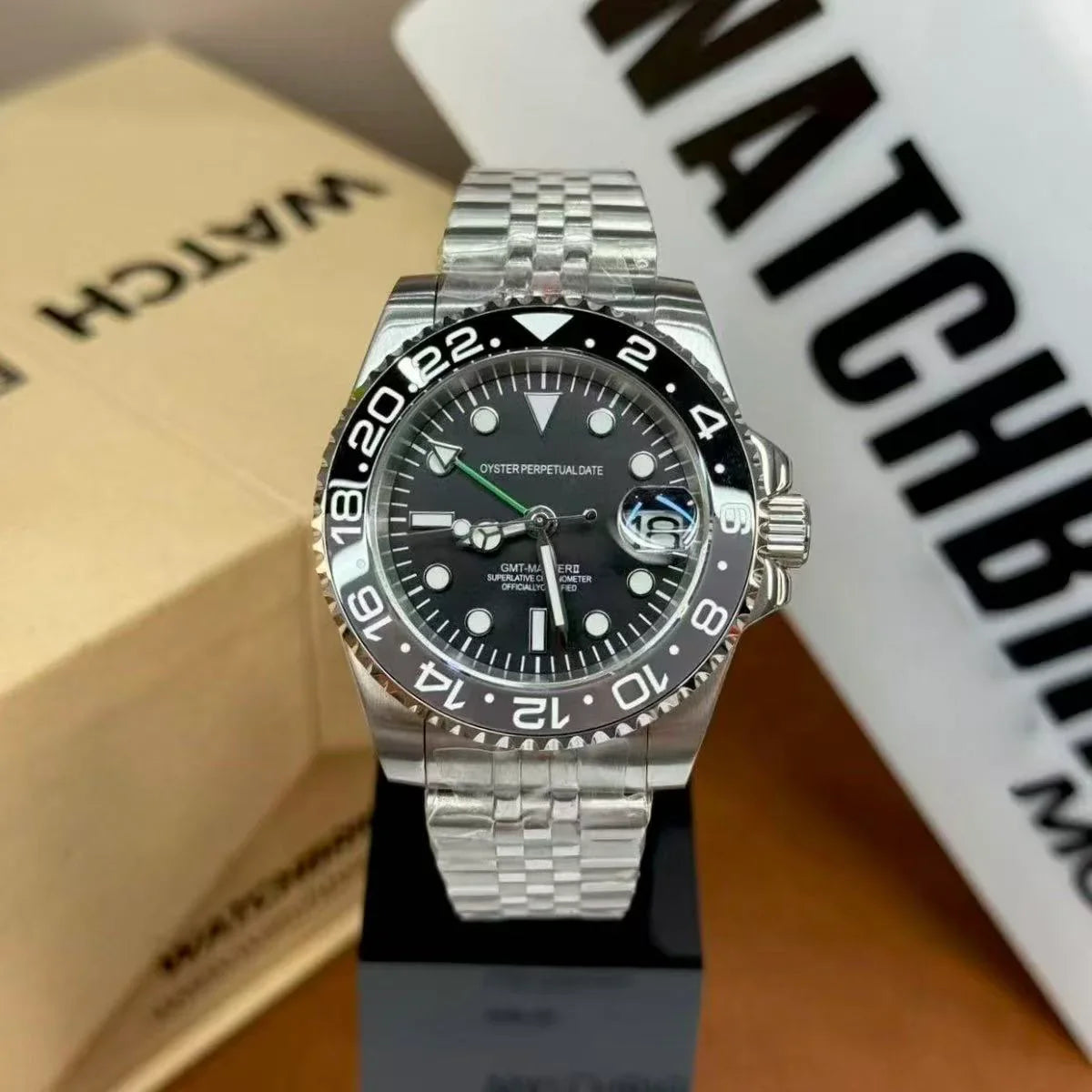 Stainless steel GMT style mod watch with black rotating bezel, Jubilee bracelet, and date display