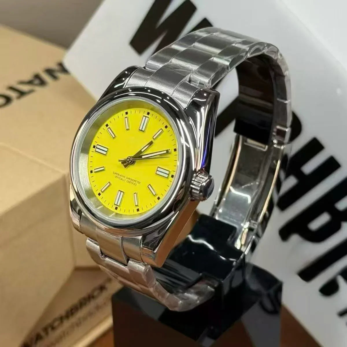 Stainless steel Seiko mod watch with bright yellow dial and silver hour markers on display stand