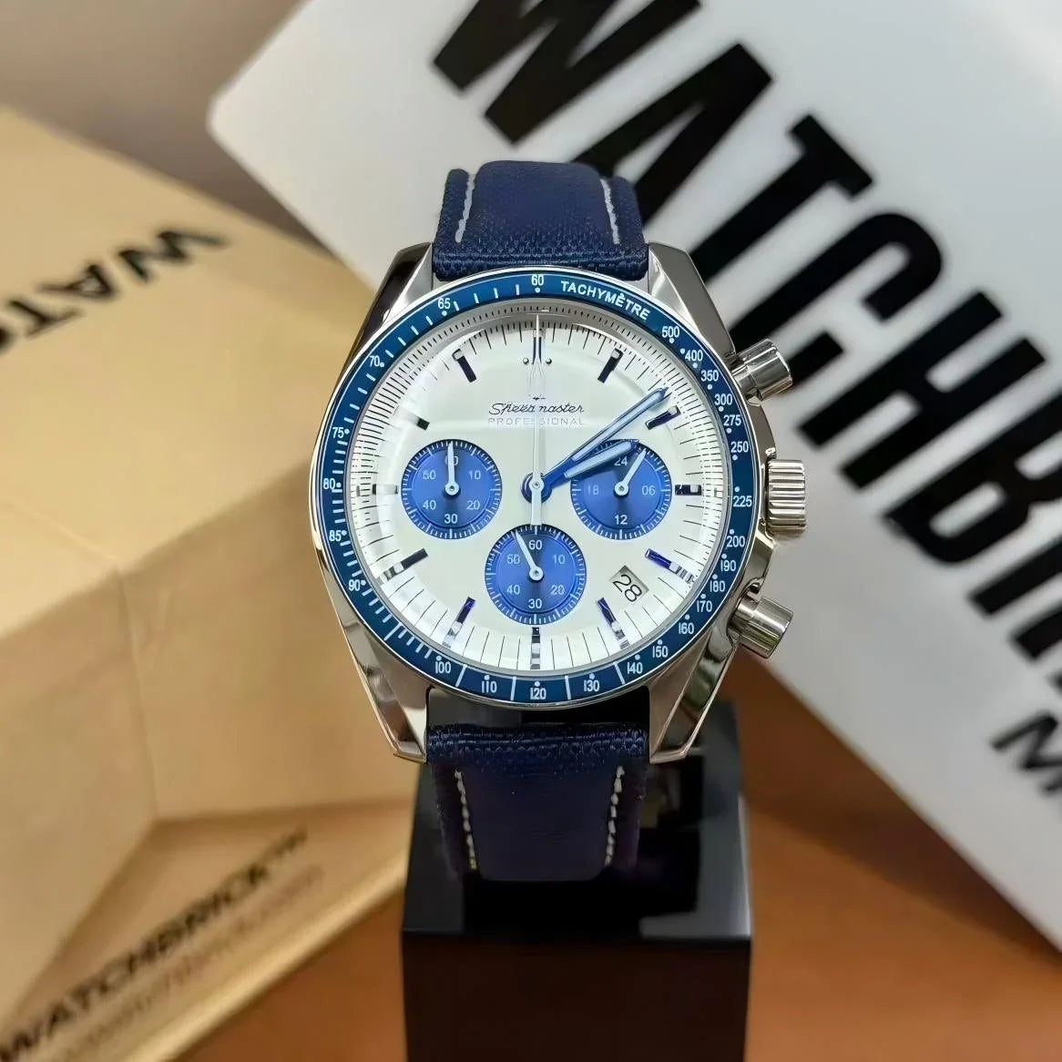 Blue and white chronograph mod watch with tachymeter bezel, blue strap, and three subdials.
