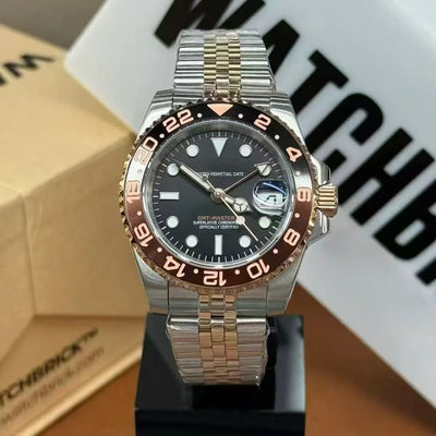 Two-tone GMT Master style watch with black dial, ceramic bezel, and jubilee bracelet on display stand