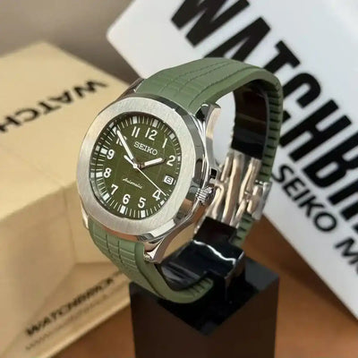 Seiko mod watch with green jungle dial and matching green rubber strap on display stand