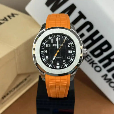 Seiko mod watch with black dial, luminous markers, and volcano orange silicone strap