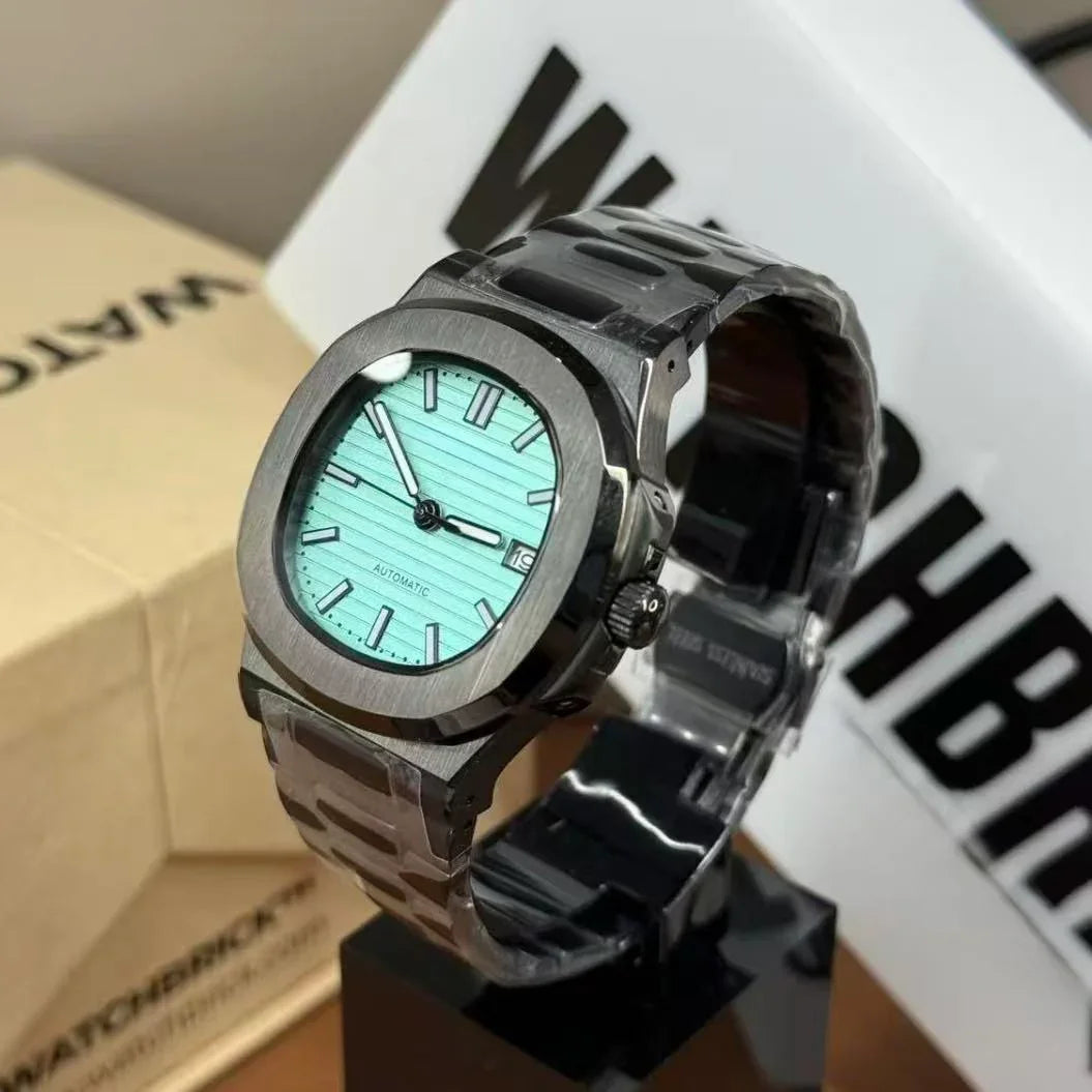 Stainless steel modded watch with turquoise dial and date display on display stand
