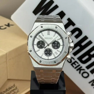 Silver Seiko mod chronograph watch with white textured dial and black subdials on display.