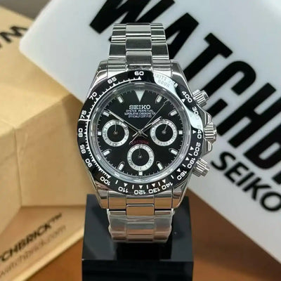 Stainless steel Seiko mod chronograph watch with black dial and three subdials on display.
