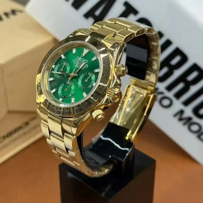Gold Seiko mod chronograph watch with green dial and sapphire crystal on display stand
