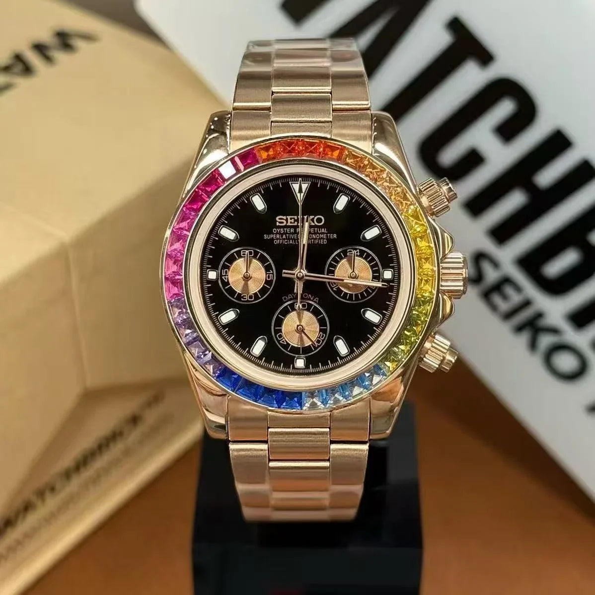 Rose gold Seiko mod watch with rainbow bezel and black dial, luxury chronograph design