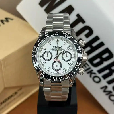 Seiko mod chronograph watch with white panda dial, black tachymeter bezel, and stainless steel bracelet
