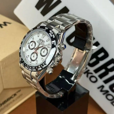 Stainless steel Seiko chronograph mod watch with white panda dial and black bezel on display stand
