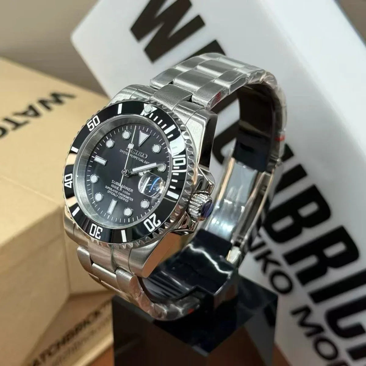 Black dive watch with stainless steel bracelet, rotating bezel, and luminous markers on display.