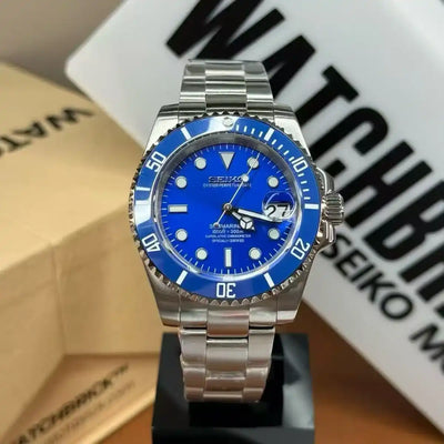 Blue dial Seiko mod automatic watch with stainless steel bracelet on display stand