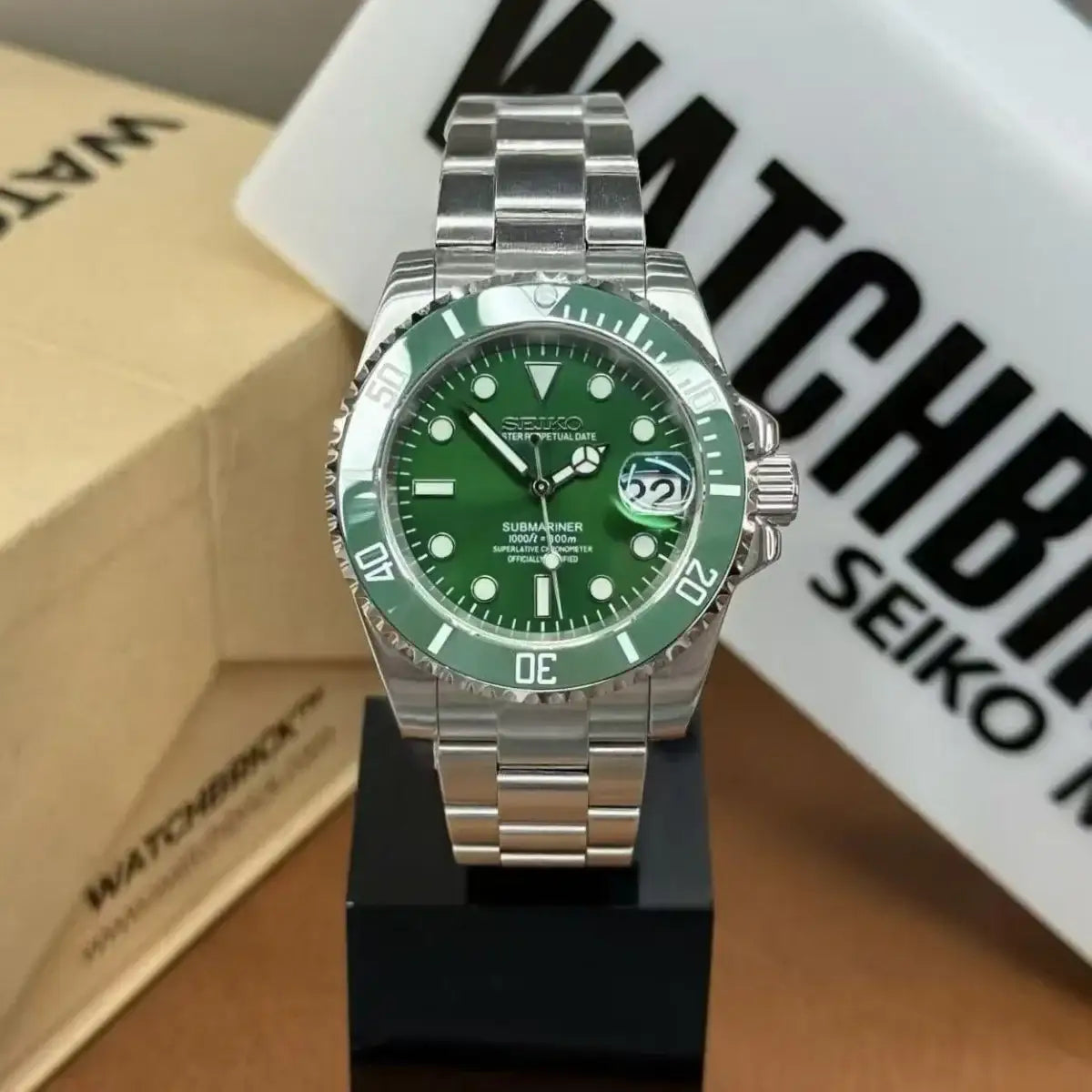 Seiko mod watch with green dial and bezel, stainless steel bracelet, date display
